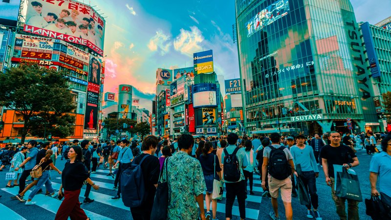 Shibuya Crossing with pedestrians and the surrounding buildings